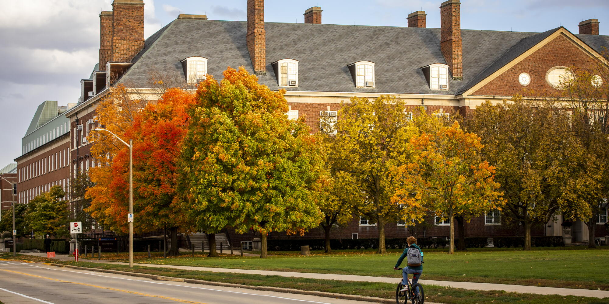 Autumn landscape with the library building and a person riding a bike