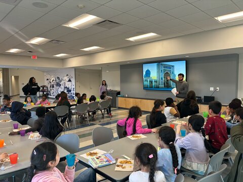 a young man giving a presentation about Uzbekistan